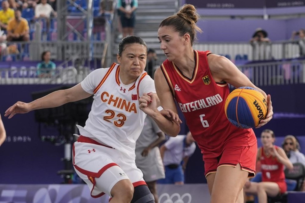 Germany's Sonja Greinacher, right, drives past China's Wang Lili in the women's 3x3 basketball pool round match during the 2024 Summer Olympics, Friday, Aug. 2, 2024, in Paris, France. Germany won 18-15. (AP Photo/Frank Franklin II)