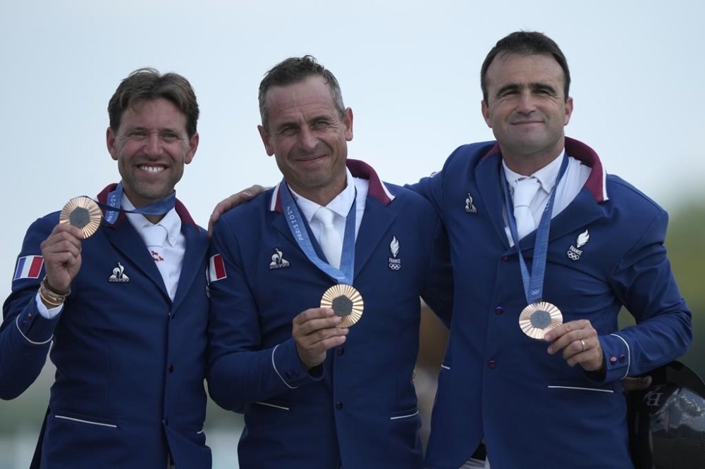 France's Simon Delestre, left, Julien Epaillard, center, and Olivier Perreau show their bronze medals after the Equestrian Jumping Team final at the 2024 Summer Olympics, Friday, Aug. 2, 2024, in Versailles, France. (AP Photo/Mosa'ab Elshamy)