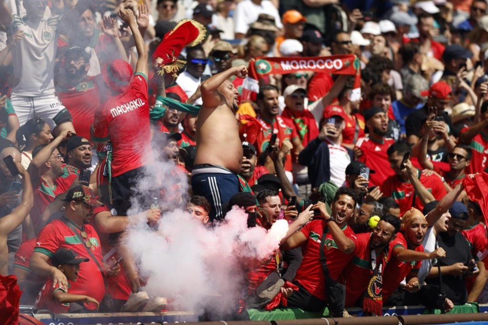 Morocco supporters celebrate after Soufiane Rahimi scored the opening goal from the penalty spot during the quarterfinal men's soccer match between Morocco and the United States at the Parc des Princes during the 2024 Summer Olympics, Friday, Aug. 2, 2024, in Paris, France. (AP Photo/Aurelien Morissard)