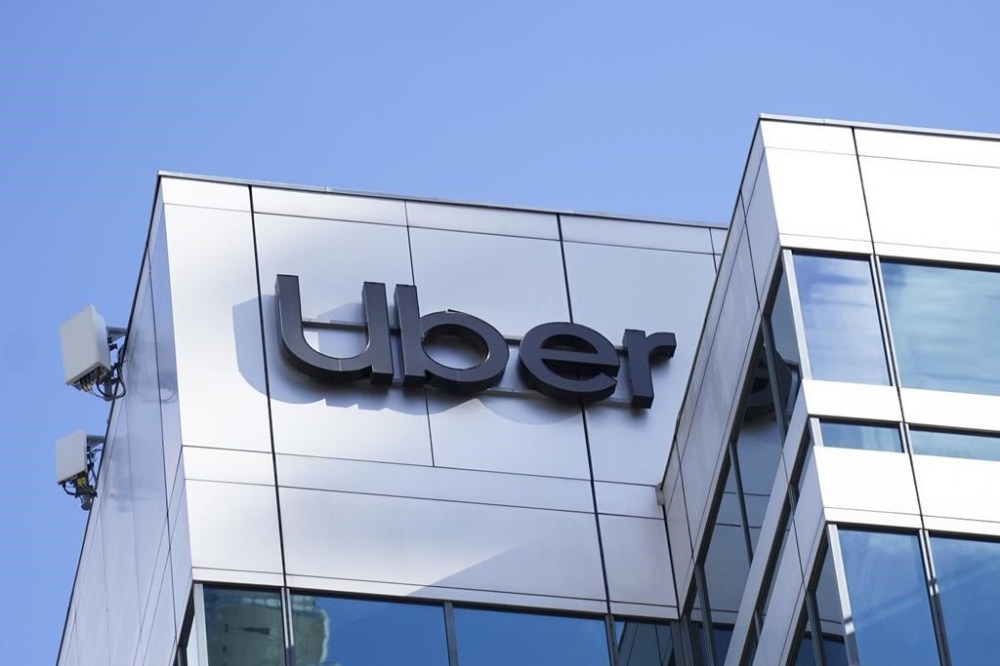 A pair of law firms say an Alberta court has certified a class action alleging Uber Technologies Inc. has so much control over drivers and couriers in the province that it constitutes employment. An Uber sign is pictured in Toronto on Wednesday, Feb. 14 2024. THE CANADIAN PRESS/Arlyn McAdorey