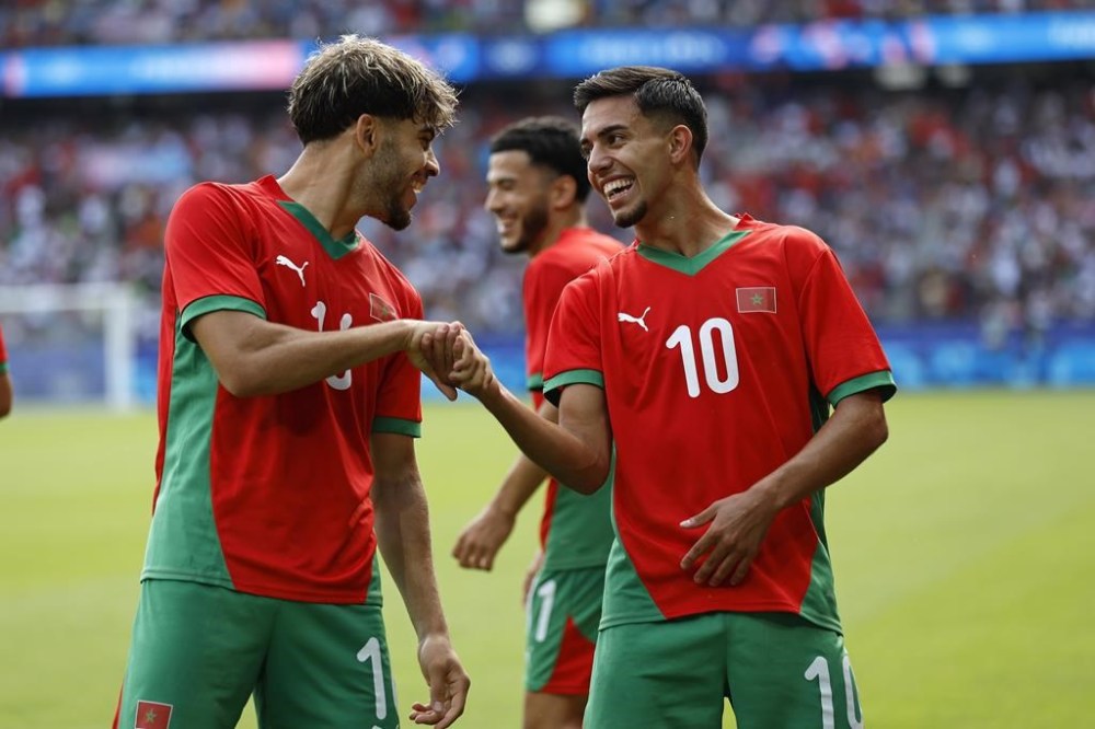 Morocco's Ilias Akhomach, right, celebrates scoring his side's second goal during the quarterfinal men's soccer match between Morocco and the United States at the Parc des Princes during the 2024 Summer Olympics, Friday, Aug. 2, 2024, in Paris, France. (AP Photo/Aurelien Morissard)