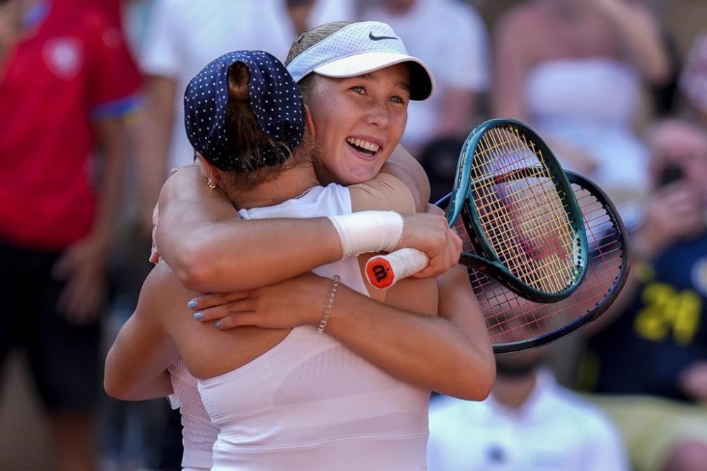 Mirra Andreeva and Diana Shnaider of Individual Neutral Athlete celebrate their victory over Cristina Bucsa and Sara Sorribes Tormo of Spain during women's doubles semifinals tennis match at the Roland Garros stadium, at the 2024 Summer Olympics, Friday, Aug. 2, 2024, in Paris, France. (AP Photo/Manu Fernandez)