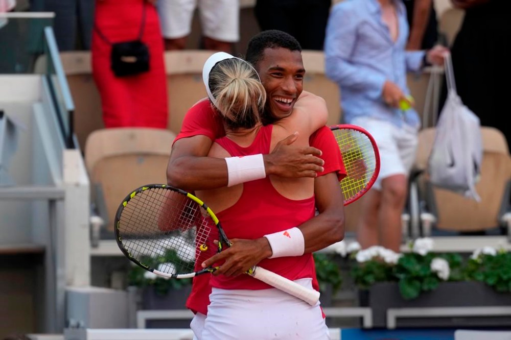 Canada's Felix Auger-Aliassime and Gabriela Dabrowski celebrate their win in the mixed doubles bronze-medal match against Demi Schuurs and Wesley Koolhoof of the Netherlands at the Summer Olympics in Paris on Friday, Aug.2, 2024. THE CANADIAN PRESS/Adrian Wyld