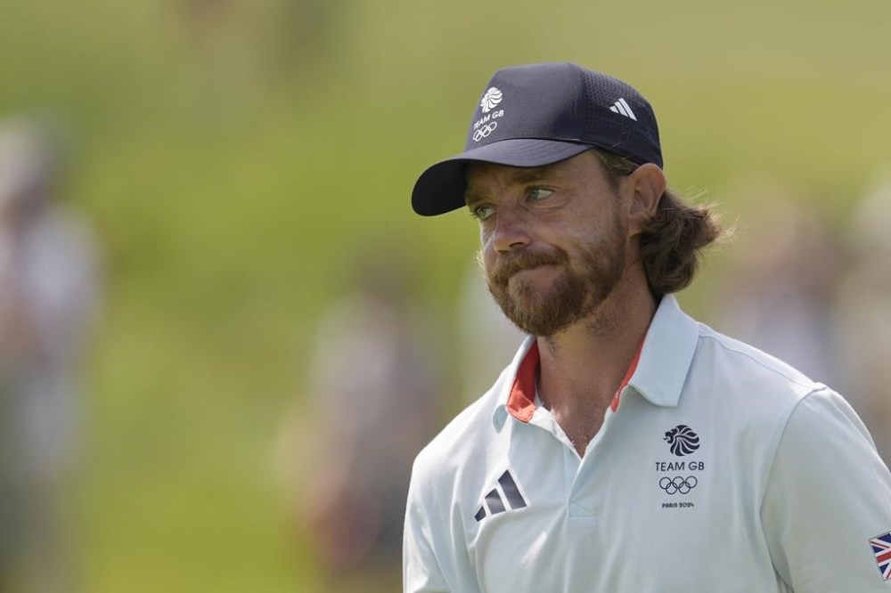 Tommy Fleetwood, of Britain, reacts after playing his tee shot on the 6th during the second round of the men's golf event at the 2024 Summer Olympics, Friday, Aug. 2, 2024, at Le Golf National in Saint-Quentin-en-Yvelines, France. (AP Photo/George Walker IV)