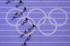 Sha'carri Richardson, right, of the United States, runs in women's 100-meter heat at the 2024 Summer Olympics, Friday, Aug. 2, 2024, in Saint-Denis, France. (AP Photo/David J. Phillip)