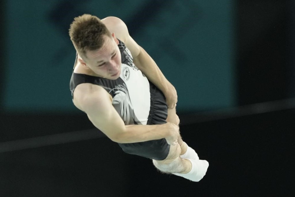 Ivan Litvinovich of the Individual Neutral Athletes competes during the men's trampoline finals in Bercy Arena at the 2024 Summer Olympics, Friday, Aug. 2, 2024, in Paris, France. (AP Photo/Charlie Riedel)