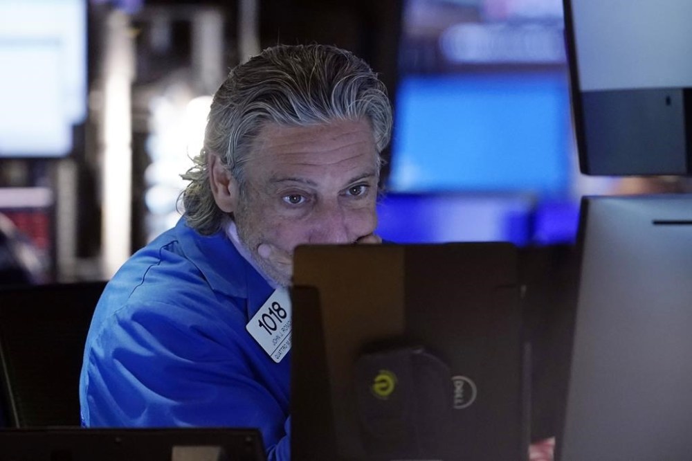 Trader John Romolo works on the floor of the New York Stock Exchange, Friday, Aug. 2, 2024. (AP Photo/Richard Drew)