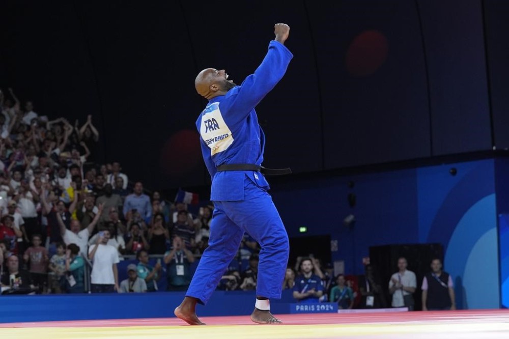 France's Teddy Riner celebrates after defeating South Korea's Kim Min-jong during their men's +100 kg final match in the team judo competition, at Champ-de-Mars Arena, during the 2024 Summer Olympics, Friday, Aug. 2, 2024, in Paris, France. (AP Photo/Eugene Hoshiko)