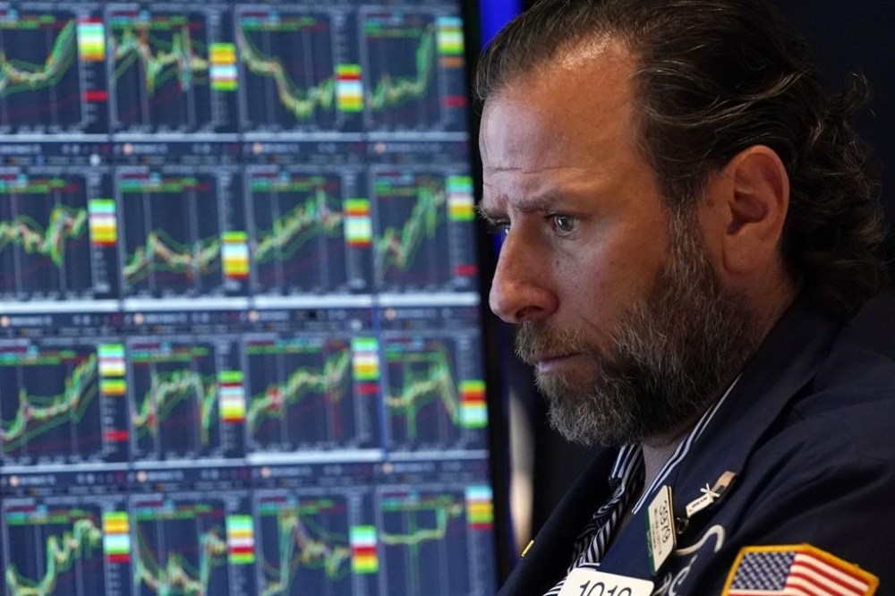 FILE - Specialist Michael Pistillo works on the floor of the New York Stock Exchange, July 31, 2024. Last month's rise in the unemployment rate has set off new worries about the threat of a recession, but it could also be a false alarm. The distorted post-pandemic economy has already confounded a host of traditional recession signals, at least so far. (AP Photo/Richard Drew, File)