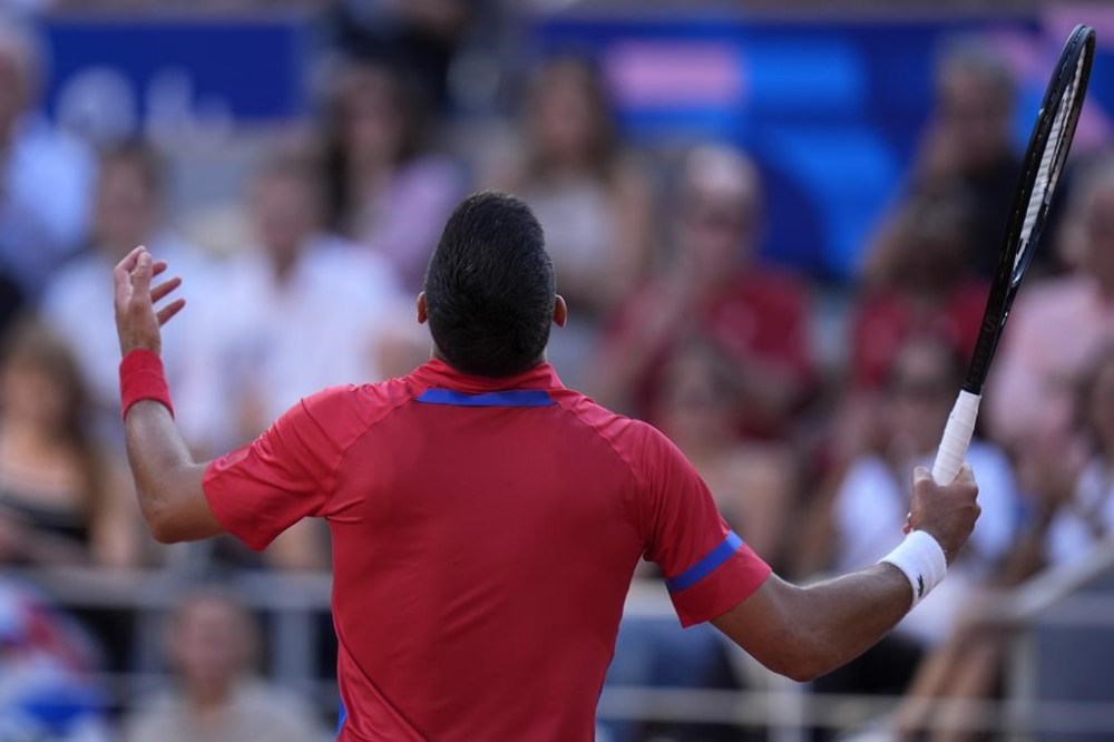 Novak Djokovic of Serbia reacts after losing a point to Lorenzo Musetti of Italy during their men's singles semifinals tennis match, at the 2024 Summer Olympics, Friday, Aug. 2, 2024, at the Roland Garros stadium in Paris, France. (AP Photo/Andy Wong)