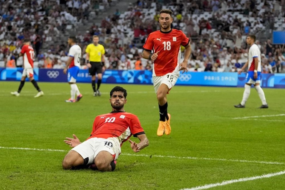 Egypt's Ibrahim Adel (10) reacts after scoring his side's first goal during a men's quarterfinal soccer match between Egypt and Paraguay at the 2024 Summer Olympics, Friday, Aug. 2, 2024, at Marseille Stadium in Marseille, France. (AP Photo/Julio Cortez)
