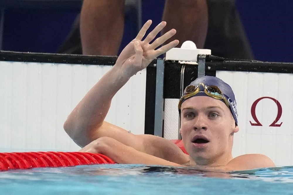 Leon Marchand of France, celebrates after winning the men's 200-meter individual medley final at the 2024 Summer Olympics, Friday, Aug. 2, 2024, in Nanterre, France. (AP Photo/Natacha Pisarenko)