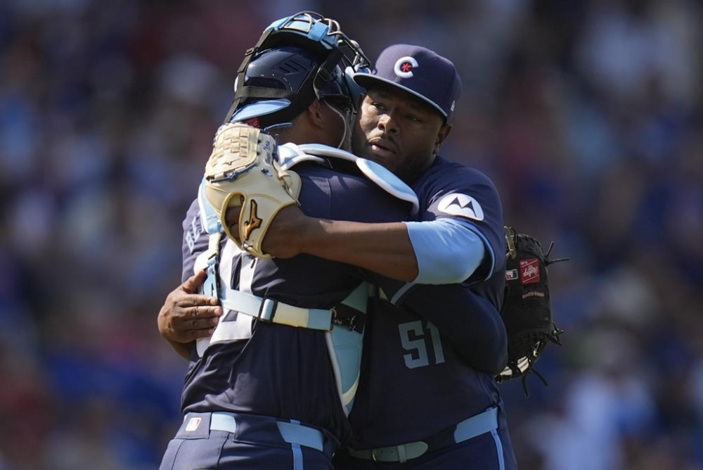 Chicago Cubs catcher Christian Bethancourt, left, and pitcher Héctor Neris, right, celebrate after their win over the St. Louis Cardinals in a baseball game Friday, Aug. 2, 2024, in Chicago. (AP Photo/Erin Hooley)