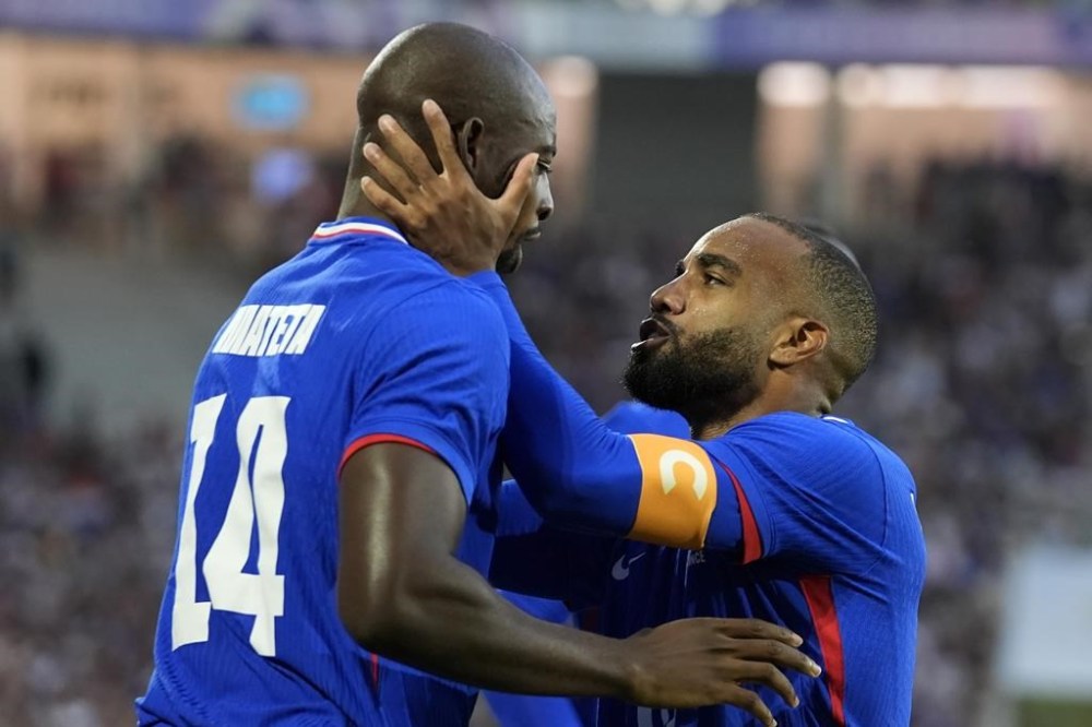 France's Jean-Philippe Mateta celebrates with Alexandre Lacazette after scoring during a quarter final soccer match between France and Argentina, at Bordeaux Stadium, during the 2024 Summer Olympics, Friday, Aug. 2, 2024, in Bordeaux, France. (AP Photo/Rebecca Blackwell)