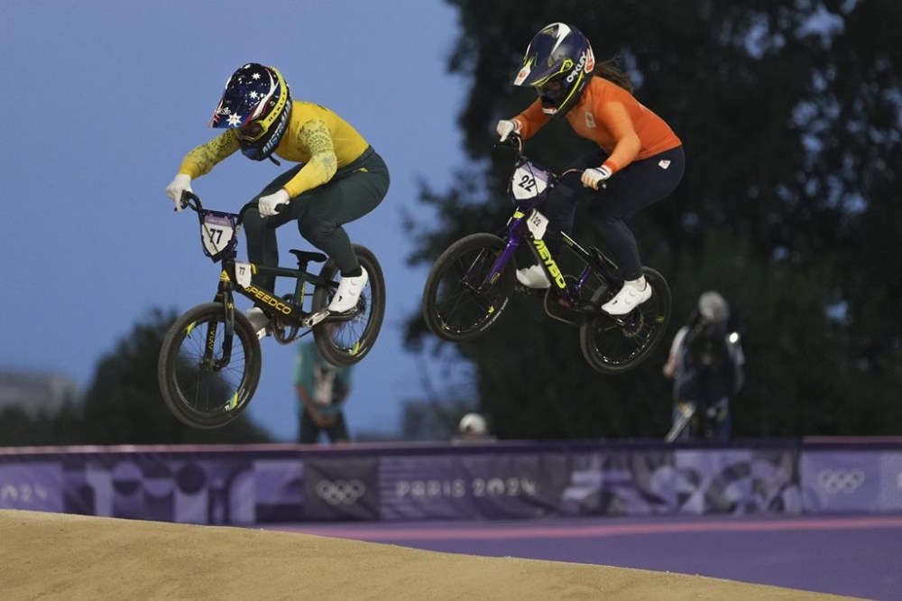 Saya Sakakibara of Australia, left, and Merel Smulders of Netherlands compete in a BMX racing event, at the 2024 Summer Olympics, Friday, Aug. 2, 2024, in Saint-Quentin-en-Yvelines, France. (AP Photo/Thibault Camus)