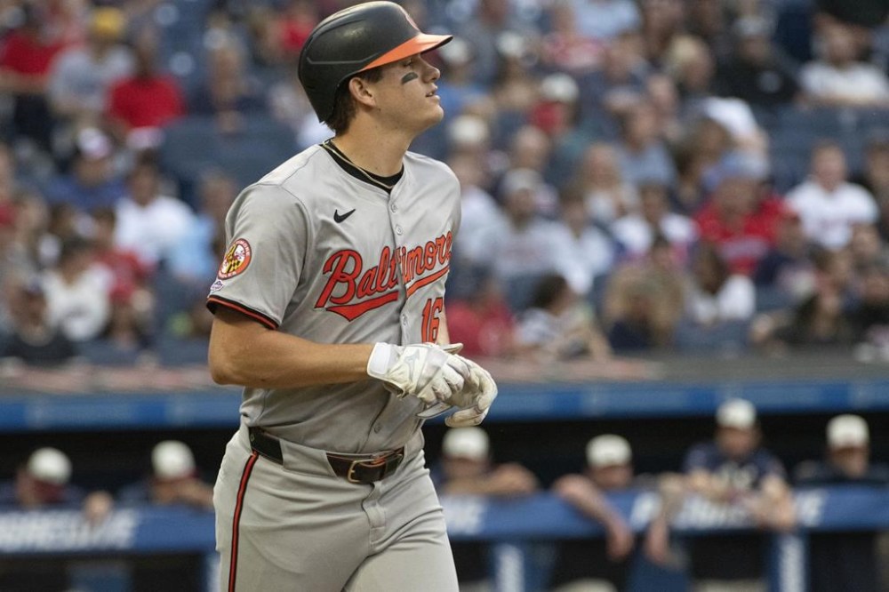 Baltimore Orioles' Coby Mayo heads to first base with a walk by Cleveland Guardians starting pitcher Carlos Carrasco during the second inning of a baseball game in Cleveland, Friday, Aug. 2, 2024. It was Mayo's first major league at-bat. (AP Photo/Phil Long)