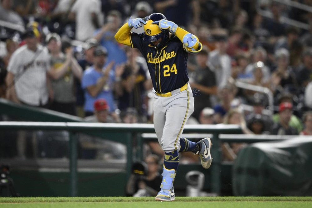 Milwaukee Brewers' William Contreras celebrates after his home run as he rounds the bases during the seventh inning of a baseball game against the Washington Nationals, Friday, Aug. 2, 2024, in Washington. (AP Photo/Nick Wass)