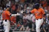 Houston Astros' Yordan Alvarez, right, celebrates with Jeremy Peña, left, after scoring during the seventh inning of a baseball game against the Tampa Bay Rays, Friday, Aug. 2, 2024, in Houston. (AP Photo/Kevin M. Cox)