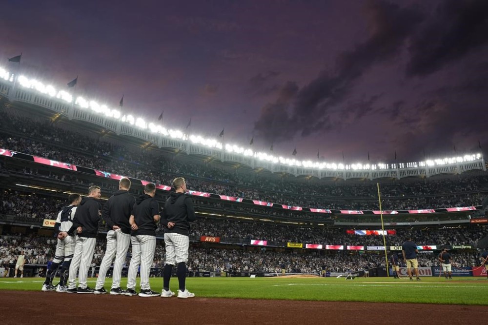 New York Yankees players stand on the field during Canada's national anthem before a baseball game against the Toronto Blue Jays, Friday, Aug. 2, 2024, in New York. (AP Photo/Pamela Smith)