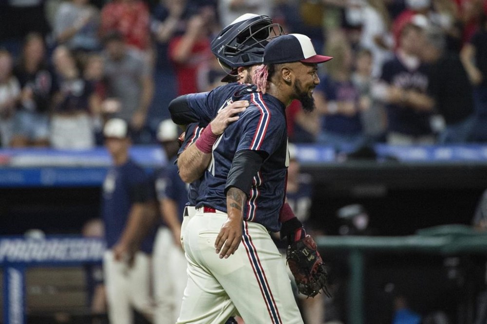 Cleveland Guardians relief pitcher Emmanuel Clase, right, smiles as he walks with Austin Hedges, left, at the end of a baseball game against the Baltimore Orioles in Cleveland, Friday, Aug. 2, 2024. (AP Photo/Phil Long)