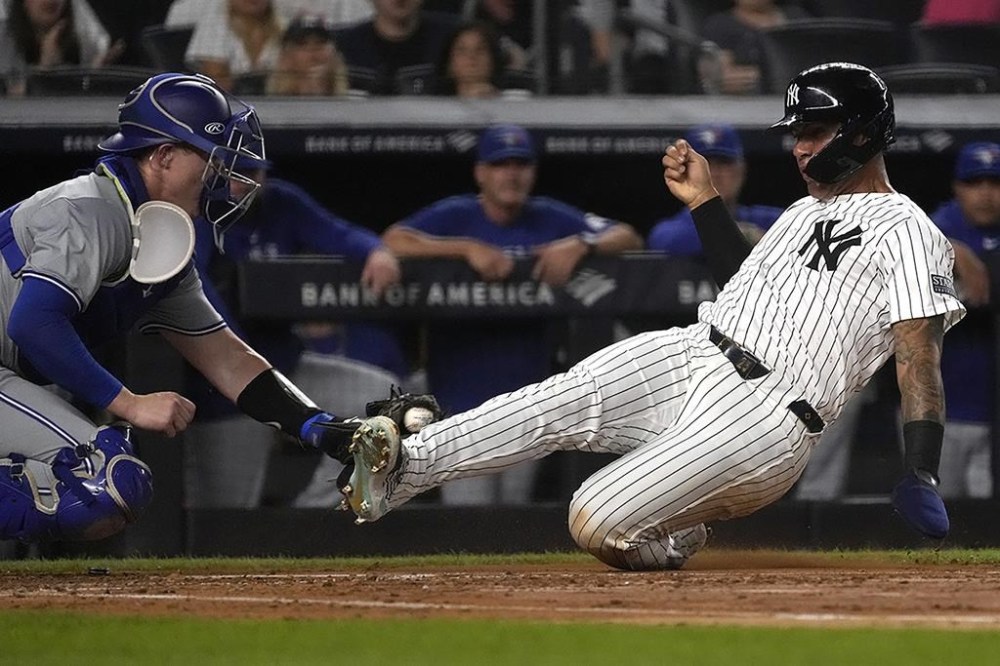 New York Yankees' Gleyber Torres, right, is tagged out at home plate by Toronto Blue Jays catcher Brian Serven, left, during the second inning of a baseball game, Friday, Aug. 2, 2024, in New York. (AP Photo/Pamela Smith)