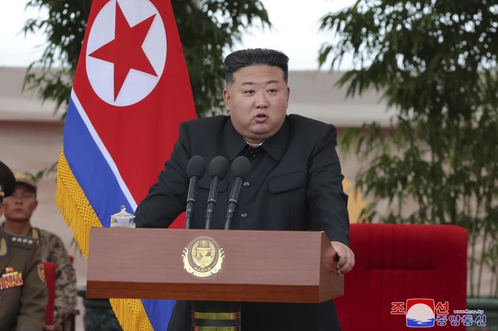 In this photo provided by the North Korean government, North Korean leader Kim Jong Un speaks as he visits an air force helicopter unit to praise the troops for helping rescue people from recent floods, at an undisclosed location in North Korea, Friday, Aug. 2, 2024. Independent journalists were not given access to cover the event depicted in this image distributed by the North Korean government. The content of this image is as provided and cannot be independently verified. Korean language watermark on image as provided by source reads: