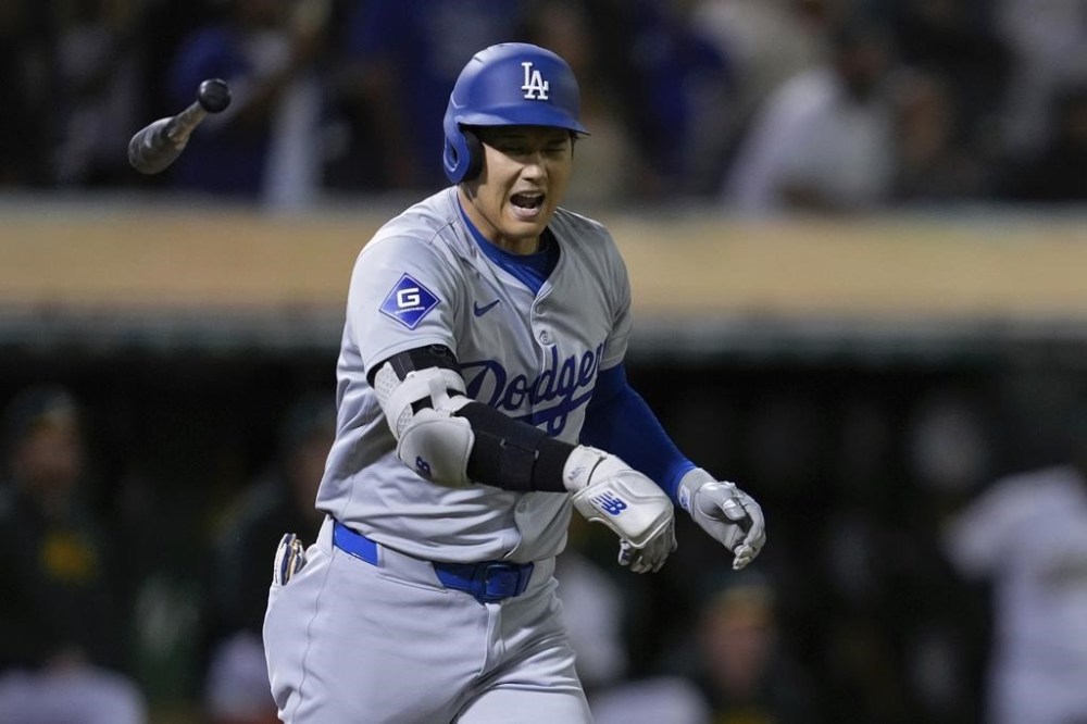 Los Angeles Dodgers' Shohei Ohtani tosses his bat after hitting a three-run home run against the Oakland Athletics during the ninth inning of a baseball game Friday, Aug. 2, 2024, in Oakland, Calif. (AP Photo/Godofredo A. Vásquez)