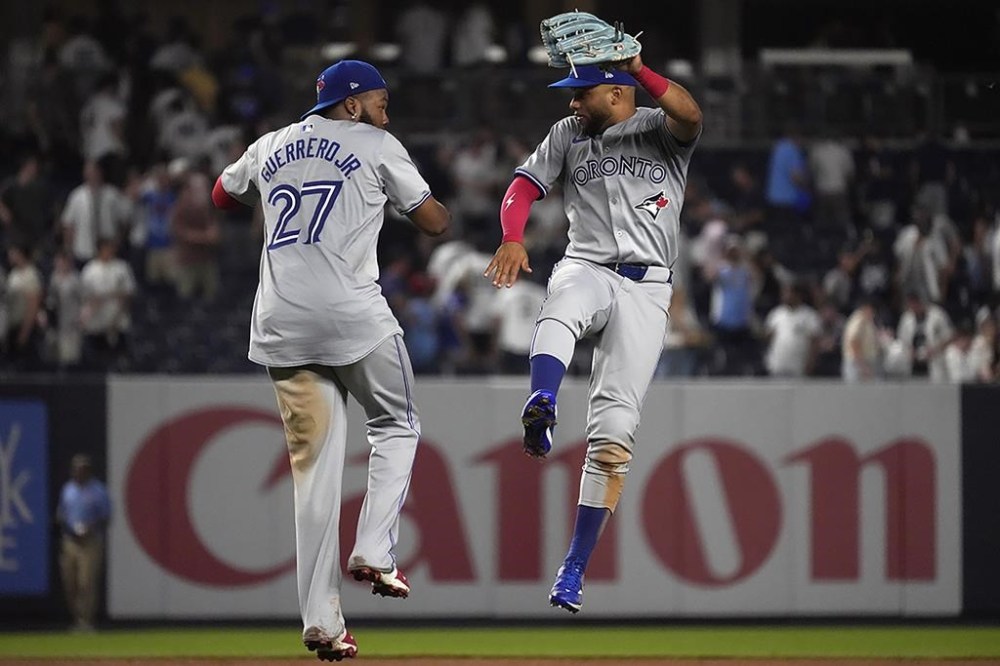 Toronto Blue Jays' Vladimir Guerrero Jr., left, and Steward Berroa, right, react after winning a baseball game against the New York Yankees, Friday, Aug. 2, 2024, in New York. (AP Photo/Pamela Smith)