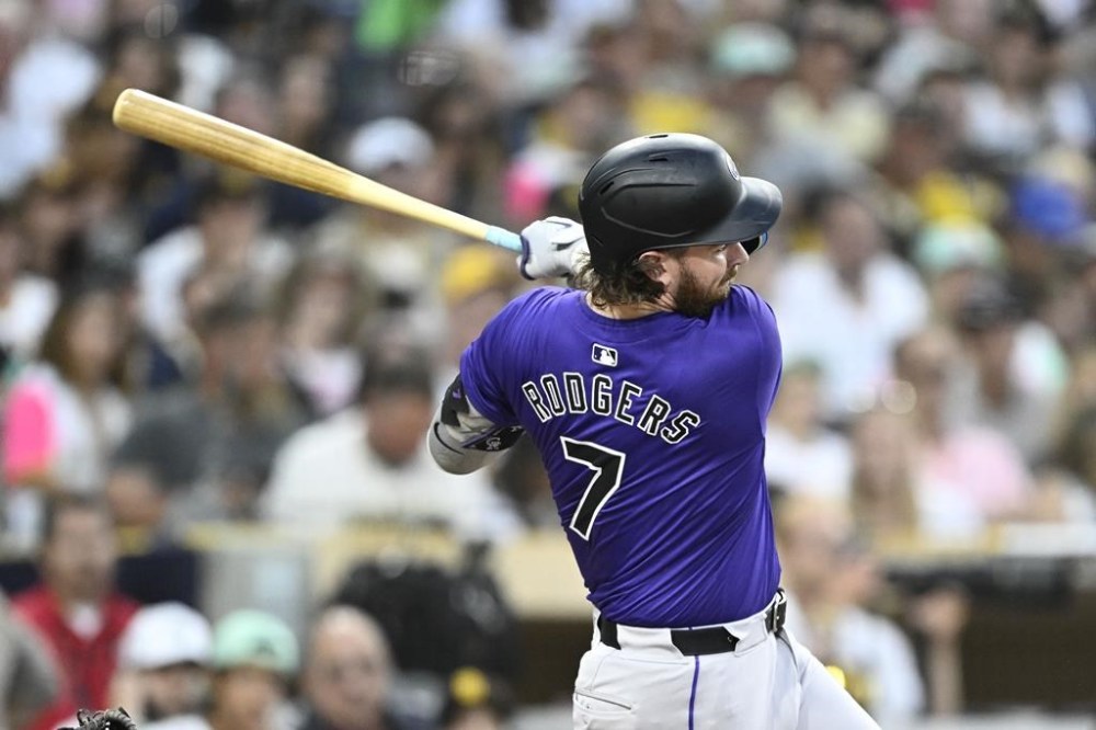 Colorado Rockies' Brendan Rodgers hits a double during the fourth inning of a baseball game against the San Diego Padres, Friday, Aug. 2, 2024, in San Diego. (AP Photo/Denis Poroy)