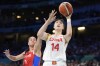 China's Li Yueru, right, shoots as Puerto Rico's Tayra Melendez defends during a women's basketball game at the 2024 Summer Olympics, Saturday, Aug. 3, 2024, in Villeneuve-d'Ascq, France. (AP Photo/Michael Conroy)