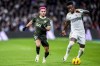 FILE - Girona's Yan Couto, left, duels for the ball with Real Madrid's Vinicius Junior during a Spanish La Liga soccer match between Real Madrid and Girona at the Santiago Bernabeu stadium in Madrid, Spain, Saturday, Feb. 10, 2024. Borussia Dortmund has signed Brazilian defender Yan Couto on loan from Manchester City with an option to make the move permanent. (AP Photo/Manu Fernandez, File)