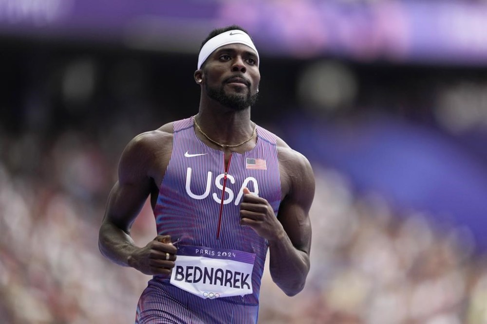 Kenneth Bednarek, of the United States, qualifies in a men's 100 meters round 1 heat at the 2024 Summer Olympics, Saturday, Aug. 3, 2024, in Saint-Denis, France. (AP Photo/Ashley Landis)