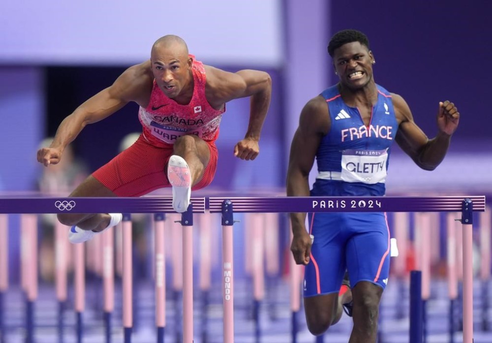 Canada's Damian Warner, left, competes in the men's 110m Hurdles in the Decathlon at the 2024 Paris Summer Olympics in Paris, France on Saturday, August 3, 2024. THE CANADIAN PRESS/Nathan Denette