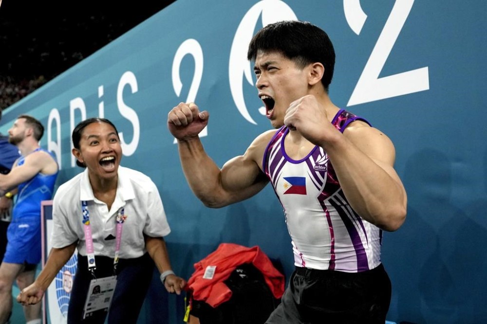 Carlos Edriel Yulo, of the Philippines, celebrates after competing during the men's artistic gymnastics individual floor finals at Bercy Arena at the 2024 Summer Olympics, Saturday, Aug. 3, 2024, in Paris, France. (AP Photo/Francisco Seco)