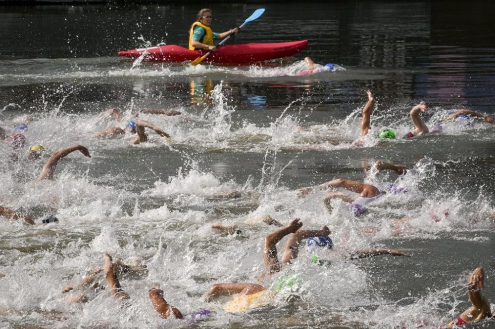 Athletes compete in the swim leg of the men's individual triathlon competition at the 2024 Summer Olympics, Wednesday, July 31, 2024, in Paris, France. (AP Photo/Dar Yasin)