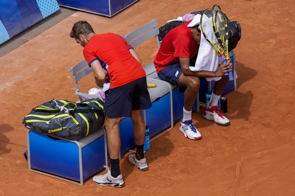 Austin Krajicek and Rajeev Ram of the United States react after losing against Australia's Matthew Ebden and John Peers during men's doubles gold medal match at the Roland Garros stadium, at the 2024 Summer Olympics, Saturday, Aug. 3, 2024, in Paris, France. (AP Photo/Manu Fernandez)