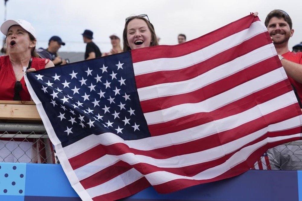 Fans of the United States watch rowing competitions at the 2024 Summer Olympics, Saturday, Aug. 3, 2024, in Vaires-sur-Marne, France. (AP Photo/Lindsey Wasson)