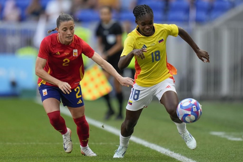 Colombia's Linda Caicedo, right, and Spain's Ona Batlle battle for the ball during the women's quarter-final soccer match between Spain and Colombia, at Lyon Stadium, during the 2024 Summer Olympics, Saturday, Aug. 3, 2024, in Decines, France. (AP Photo/Silvia Izquierdo)