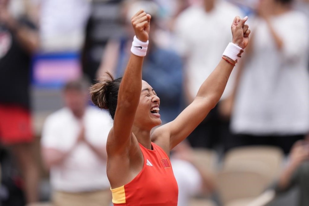 China's Zheng Qinwen reacts after defeating Croatia's Donna Vekic during the Women's Singles tennis final at the Roland Garros stadium at the 2024 Summer Olympics, Saturday, Aug. 3, 2024, in Paris, France. (AP Photo/Manu Fernandez)