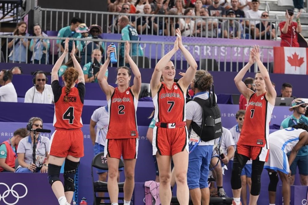Canada's Kacie Bosch (4), Katherine Plouffe (2), Paige Crozon (7) and Michelle Plouffe (1) celebrate after a women's 3x3 basketball pool round match against against Azerbaijan during the 2024 Summer Olympics, Saturday, Aug. 3, 2024, in Paris, France. Canada won 21-19. THE CANADIAN PRESS/AP-Frank Franklin II