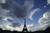 The Eiffel Tower looms over the beach volleyball venue during a match between Italy and Sweden at the 2024 Summer Olympics, Thursday, Aug. 1, 2024, in Paris, France. (AP Photo/Robert F. Bukaty)
