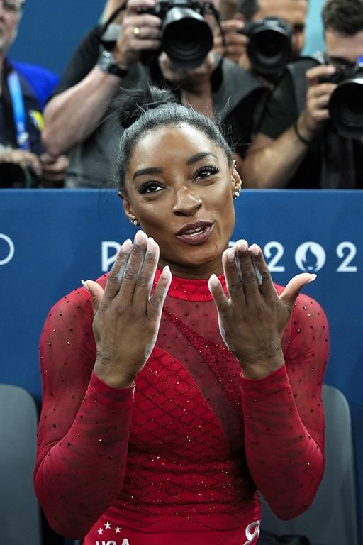 Simone Biles, of the United States, blows kisses during the women's artistic gymnastics individual vault finals at Bercy Arena at the 2024 Summer Olympics, Saturday, Aug. 3, 2024, in Paris, France. (AP Photo/Francisco Seco)