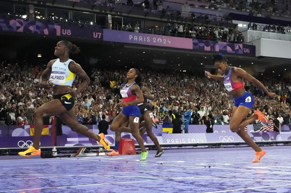 Julien Alfred, of Saint Lucia, from left, Sha'carri Richardson, of the United States, and Melissa Jefferson, of the United States, run in the women's 100-meter final at the 2024 Summer Olympics, Saturday, Aug. 3, 2024, in Saint-Denis, France. (AP Photo/David J. Phillip)