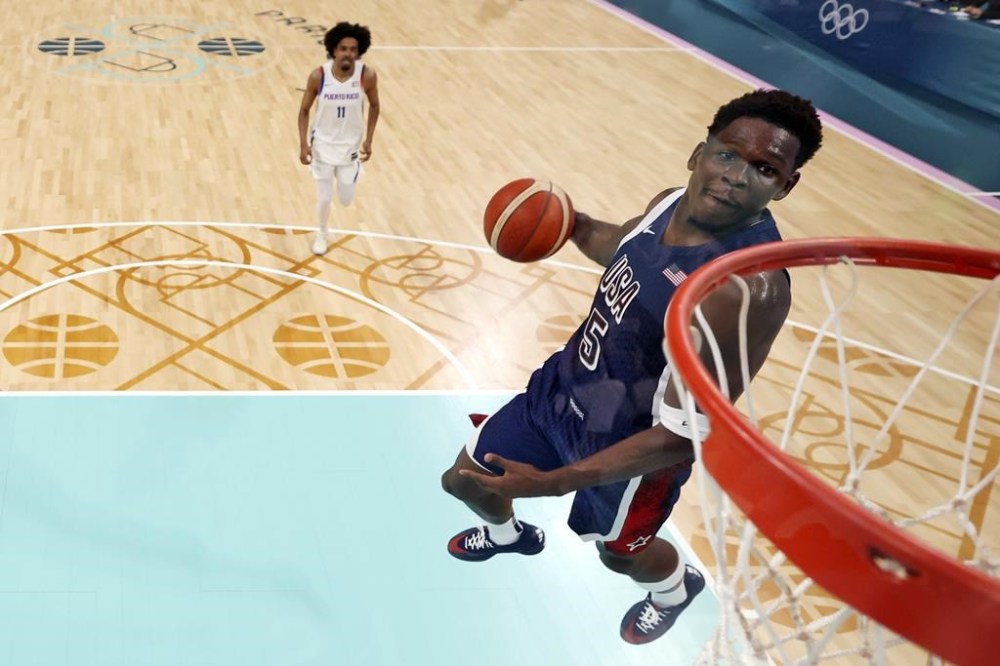 United States' Anthony Edwards dunks during a men's basketball game against Puerto Rico at the 2024 Summer Olympics, Saturday, Aug. 3, 2024, in Villeneuve-d'Ascq, France. (Gregory Shamus/Pool Photo via AP)