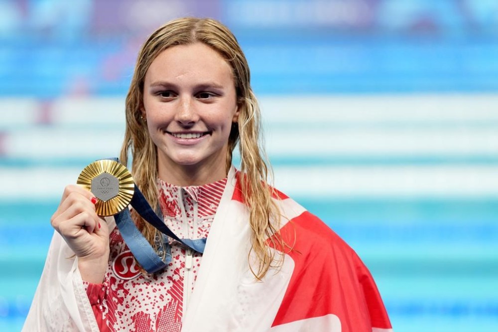 Canada's Summer McIntosh, of Toronto, celebrates with her gold medal won in the 200m women's individual medley final during the 2024 Summer Olympic Games, in Nanterre, France, Saturday, Aug. 3, 2024. THE CANADIAN PRESS/Christinne Muschi