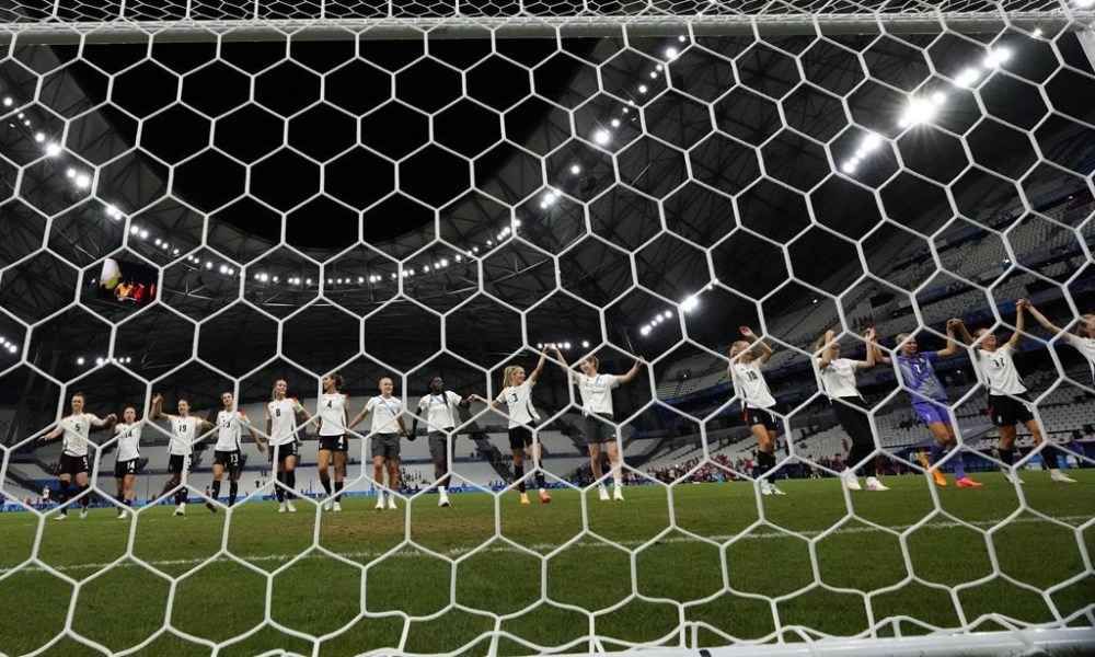 Germany players celebrate after wining a women's quarterfinal soccer match against Canada at the 2024 Summer Olympics, Saturday, Aug. 3, 2024, at Marseille Stadium in Marseille, France. (AP Photo/Julio Cortez)