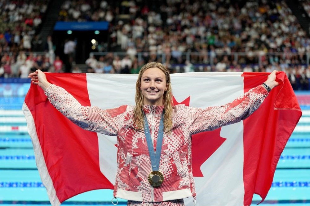 Canada's Summer McIntosh, of Toronto, celebrates with her gold medal won in the 200m women's individual medley final during the 2024 Summer Olympic Games, in Nanterre, France, Saturday, Aug. 3, 2024. THE CANADIAN PRESS/Christinne Muschi