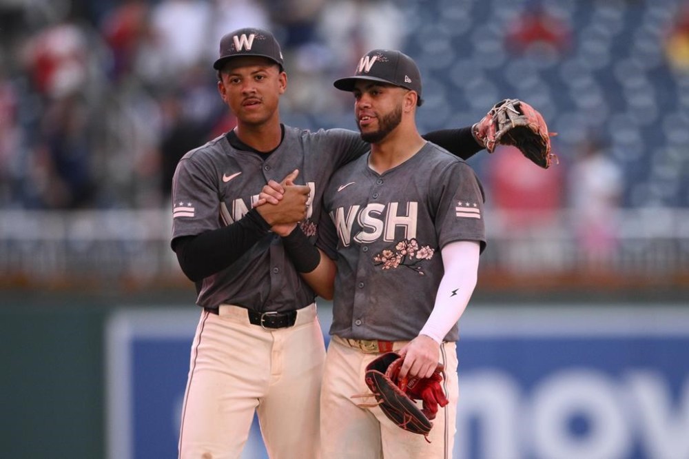 Washington Nationals' Trey Lipscomb, left, and Luis Garcia Jr., right, celebrate after a baseball game against the Milwaukee Brewers, Saturday, Aug. 3, 2024, in Washington. (AP Photo/Nick Wass)