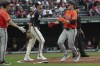Baltimore Orioles' Coby Mayo, left, congratulates Gunnar Henderson, front right, for scoring on an RBI single by Eloy Jimenez as Cleveland Guardians starting pitcher Joey Cantillo, second from left, looks away during the fourth inning of a baseball game in Cleveland, Saturday, Aug. 3, 2024. (AP Photo/Phil Long)