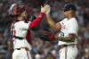 Minnesota Twins catcher Ryan Jeffers, left, and relief pitcher Jhoan Duran, right, celebrate after their win over the Chicago White Sox in a baseball game Saturday, Aug. 3, 2024, in Minneapolis. (AP Photo/Matt Krohn)